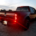 Upgrade your Ford F-150/Raptor with Recon's Dark Red/Smoke OLED Tail Lights (264368RBK). Enhance style, visibility, and safety in a sleek, modern design.
